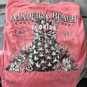 Surf style shirt with two designs on it. The color is a peach color.